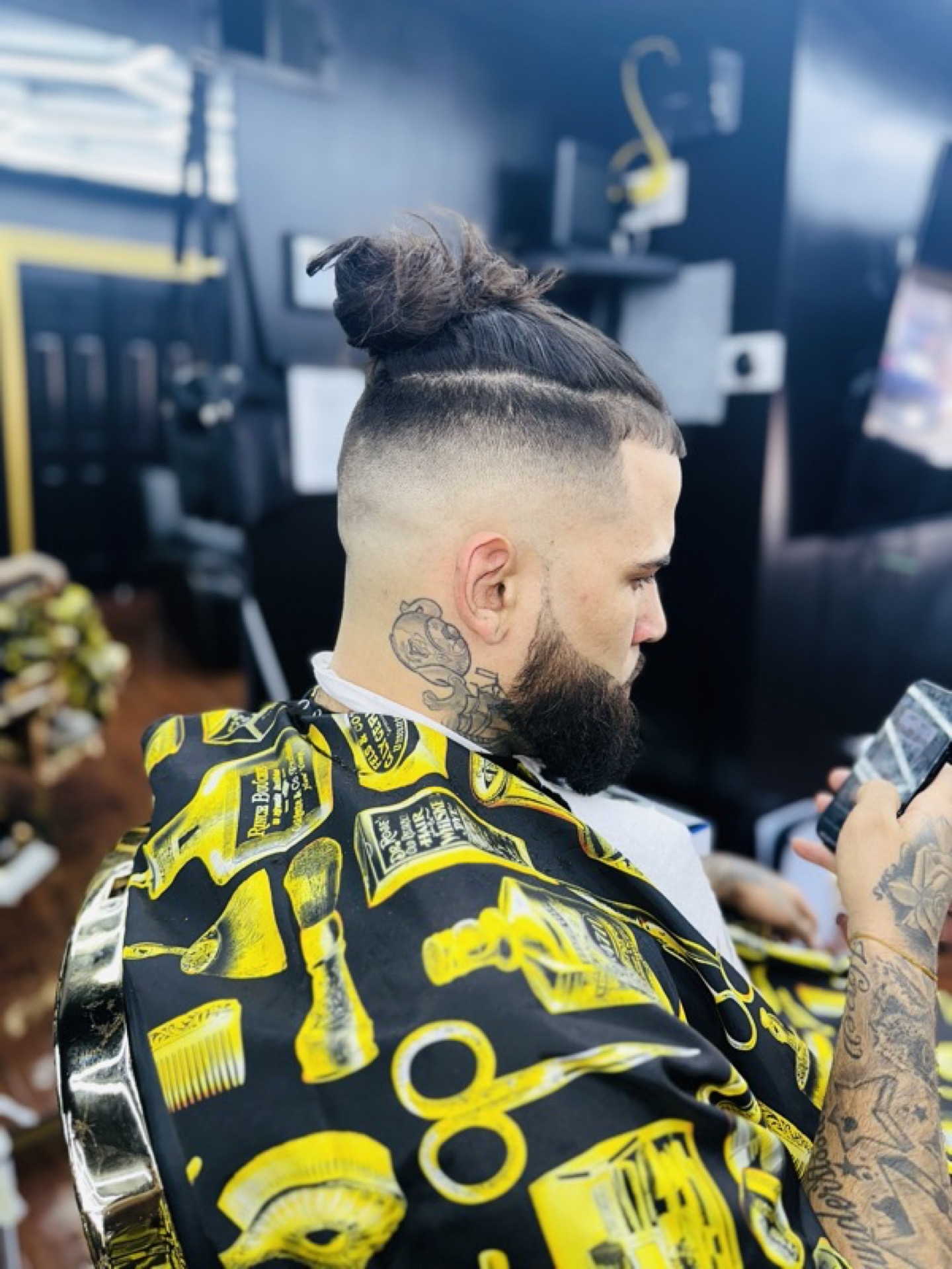 Man bun with skin fade and beard